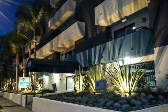 Laurel Canyon, California multi-family residential building entryway with dramatic lighting in landscaped beds at nighttime