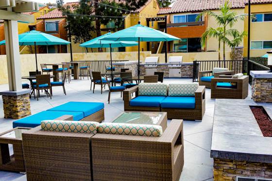 Well-made arbor and raised fire pit with stone masonry and poured concrete as part of a residential courtyard in Topanga Canyon, California