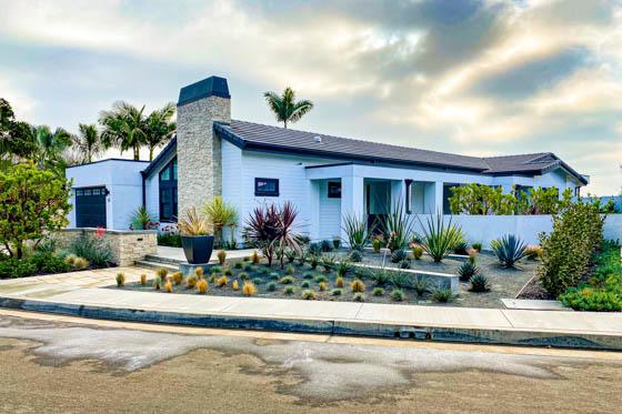 Close up of fire pit, poured concrete steps, spa with waterfall feature, and pool with a dramatic view