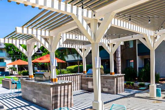 White arbor over U-shaped grill area at a residential condominium landscaping project